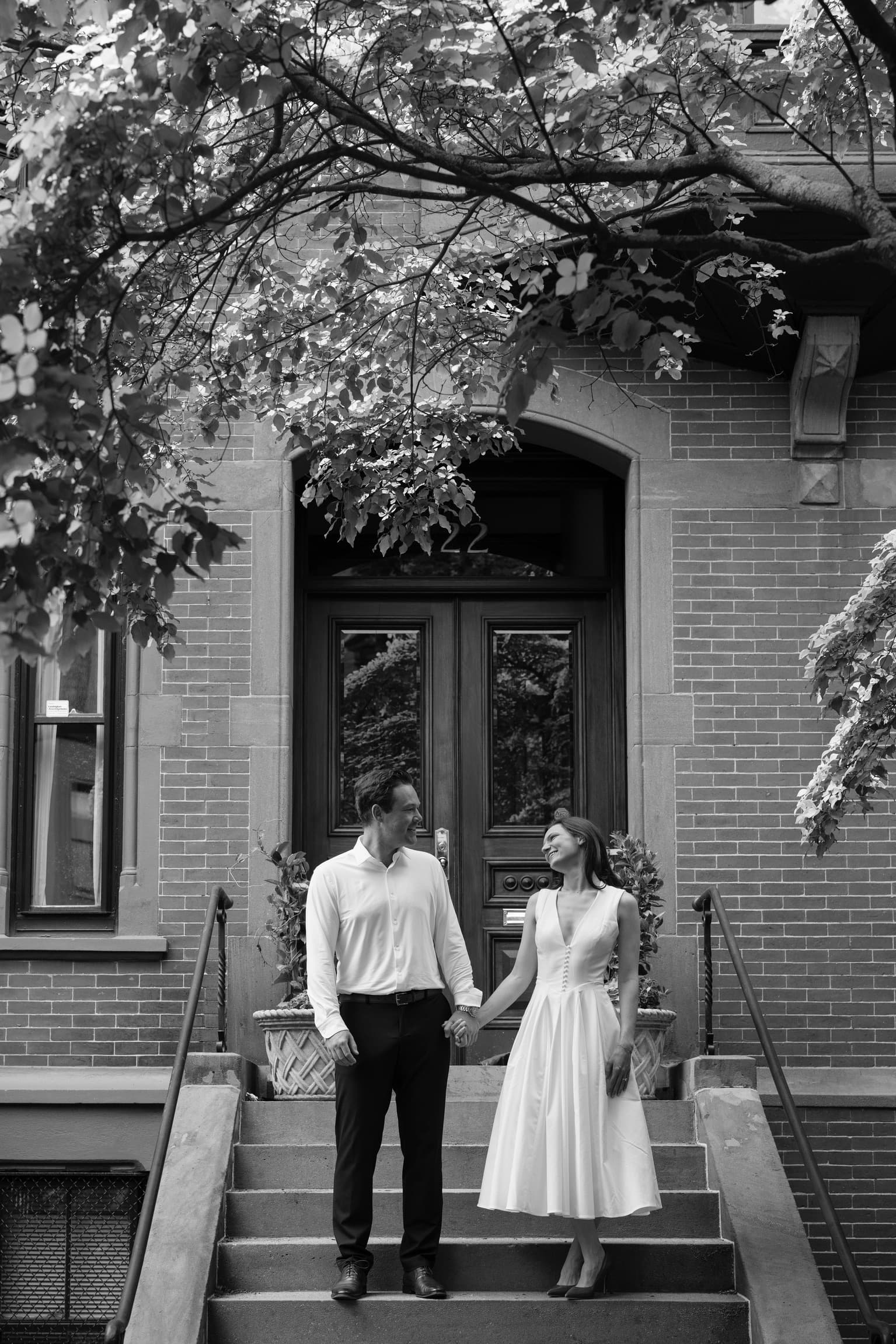 Julia & Zach standing together on stone steps